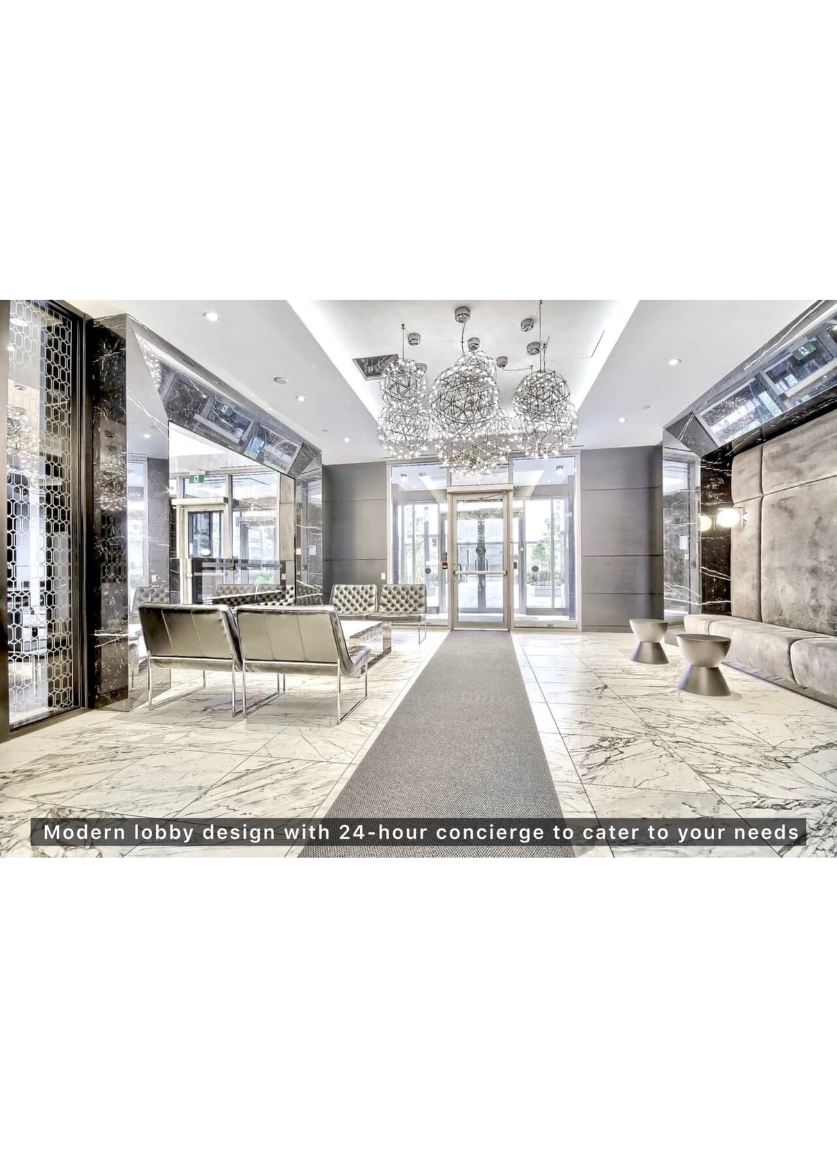 Modern lobby with marble floors, metallic seating, and large orb chandeliers leading to glass doors.